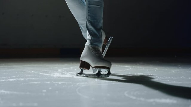 Cinematic close-up shot of a female make a pose on ice skate