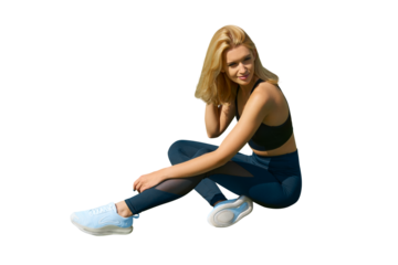 Fit woman in sitting on the floor isolated on white. Slim attractive female with flat belly relaxed or stretching