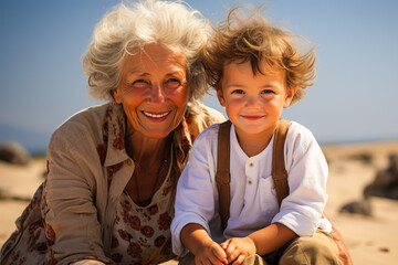 Boy and grandmother sharing a moment on summer beach.