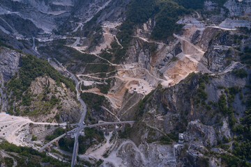 Aerial panorama of marble quarries Carrara Italy. Marble quarry top view. Industrial machinery in a quarry.