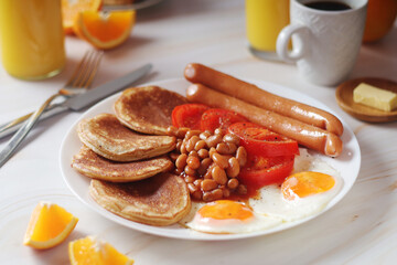 Traditional British breakfast with sausages and beans	