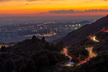 Aerial shot of Islamabad, the capital city of Pakistan showing the landmark Shah Faisal Mosque and the lush green mountains of Margala Hills, faisal