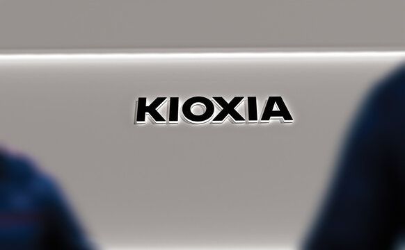 Kioxia logo on the white wall of a store. Kioxia's brand in a showroom.