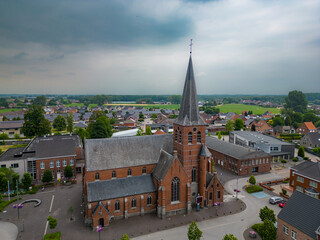 Rijkevorsel, Belgium, 28 June 2023. Sint Jozef Rijkevorsel old street and a view of Saint Joseph's Church from high pov. Aerial drone view. High quality photo. High quality photo - obrazy, fototapety, plakaty