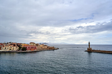 Fototapeta premium Port quay and historic lighthouse in the town of Chania on the island of Crete