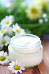 Obraz na płótnie Canvas Cosmetic moisturizing cream with flowers.
