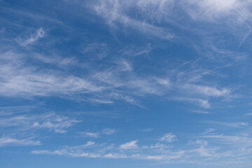 Unusual white striped wavy clouds in a bright blue sky. Heavenly background for your photos. Perfect Sky photo
