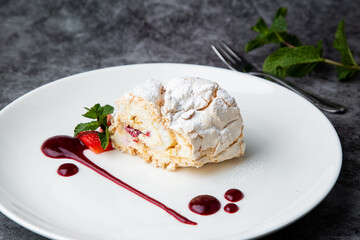 sweet sponge dessert with raspberries and powdered sugar side view