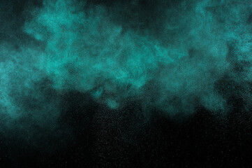 Aquamarine powder explosion on black background. Colored powder cloud. Colorful dust explode. Freeze motion paint  Holi.