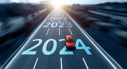 Blurred motion highway with red car, and new year number 2024, 2023 on the road