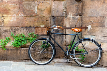 Fototapeta na wymiar Black bicycle against ancient wall