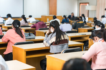 Selective focus high school or university students concentrate on language listening test in the...