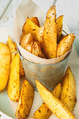 A serving of baked potato wedges in a plate. Delicious vegetarian food