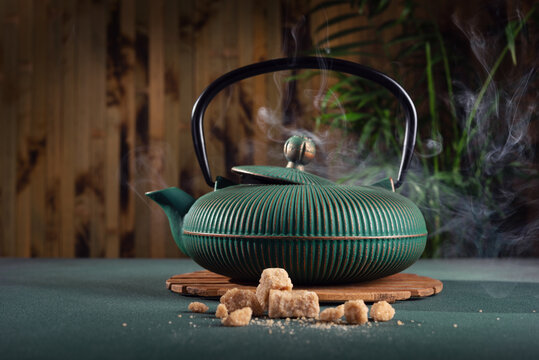 Hot tea in asian iron teapot