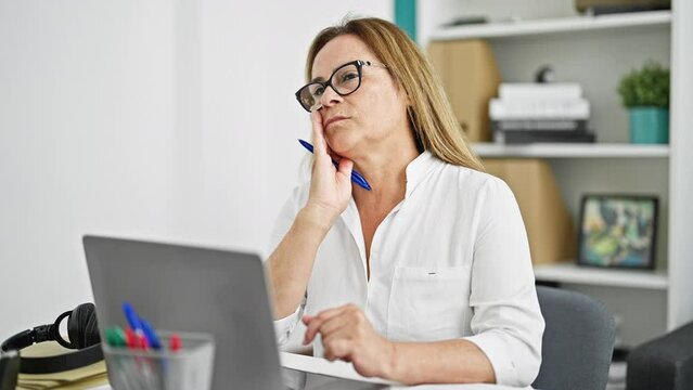 Middle age hispanic woman business worker using laptop thinking at the office