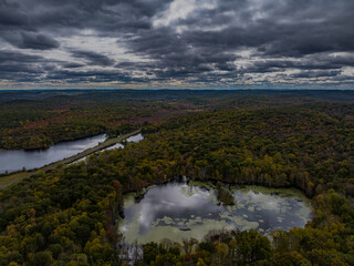 Aerial view of the countryside in Stormville, NY on a cloudy day during the colorful autumn season...