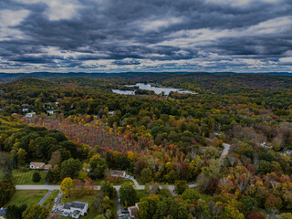 Aerial view of the countryside in Stormville, NY on a cloudy day during the colorful autumn season...
