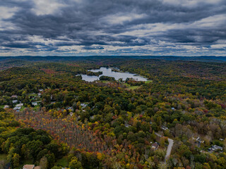 Aerial view of the countryside in Stormville, NY on a cloudy day during the colorful autumn season...