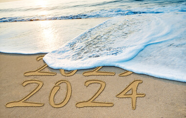 Number 2023 2024 written on the beach