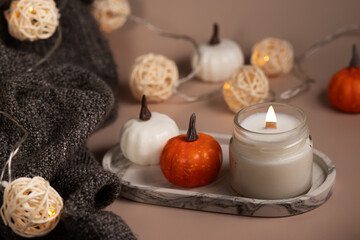 Obraz na płótnie Canvas handmade candle and cozy blanket, warmth to the home interior, comforting home atmosphere
