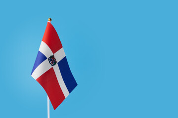 Dominican Republic flag on a blue background, copy space, independence national day of Dominican Republic, country freedom, patriotism