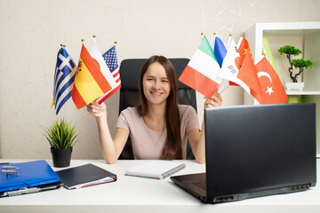 Online language course, teenager with a laptop, flags of different countries, eLearning