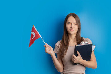 student with Turkish flag on blue background, language learning, immigration, foreign education,...