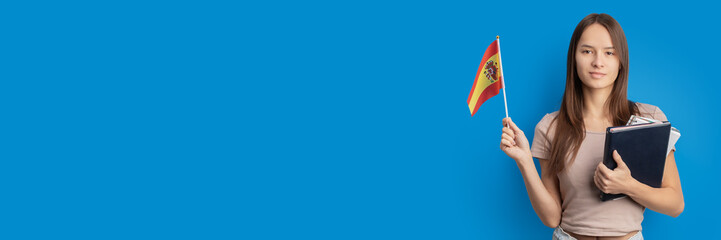 student with spanish flag on blue background, language learning, immigration, foreign education,...