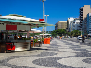 Copacabana beach with mosaic of sidewalk and kiosks in Rio de Janeiro, Brazil. Copacabana beach is...