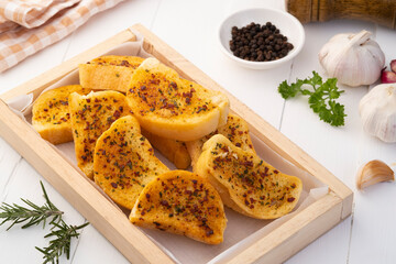 Crispy Garlic bacon Bread on wooden plate.Air fryer bread with butter garlic and parsley.Snack food