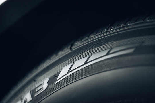 Closeup of the tread of a summer car tire on a sunny day. tires against black. fuel efficient car tires.