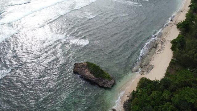 The twilight atmosphere at Watu Leter Beach is highlighted by a very unique small island