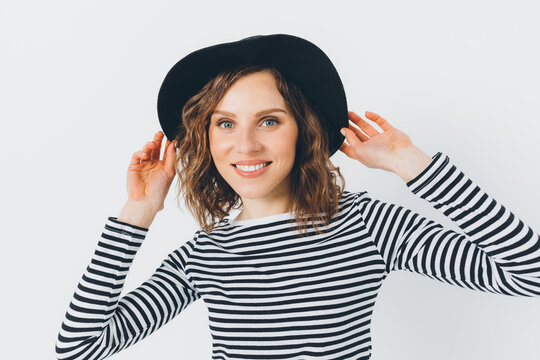Happy young woman with hat on white background