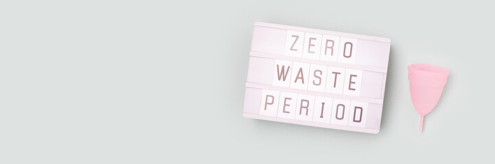 Zero waste period. Banner with lightbox and menstrual cup on a blue background. Minimal concept. - obrazy, fototapety, plakaty