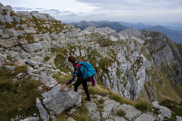 Adult Woman Hiker Hike Between Krn and Batognica Mountain on a very scenic Alpine trail in Julian...