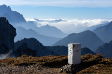 Italian border stone on the alpine border between Italy and Slovenia both European members on...