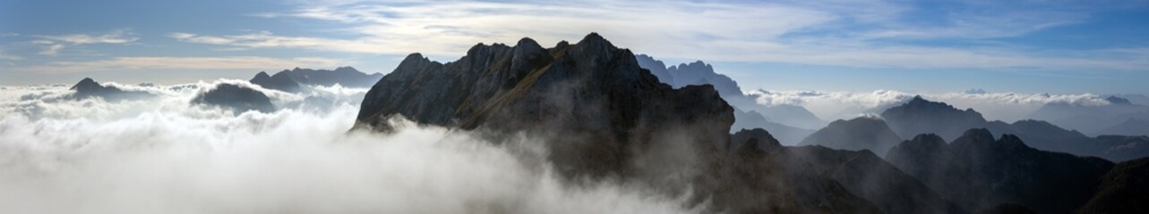 Beautiful Ultra wide panorama of European Alps in Lifting Clouds 