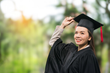 Portrait middle-age female university graduate wears academic gown celebrates diploma degree