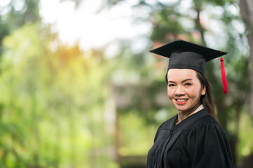 Portrait middle-age female university graduate wears academic gown celebrates diploma degree