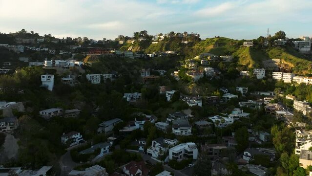 Drone flying towards luxurious mansions on Hollywood Hills in Los Angeles. luxury residences and villas in Hollywood Hills. 