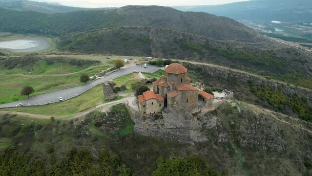 Jvari Monastery Georgian Orthodox  with city Mtskheta and clouds on blue sky