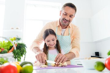 Photo of dreamy positive dad small daughter chopping knife mushrooms preparing supper together...