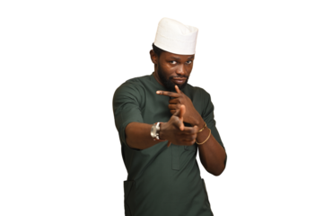 Png of A traditional businessman from the African clan wearing green attire and his white fila cap to match, In an Indoor studio, standing Isolated large copy space.