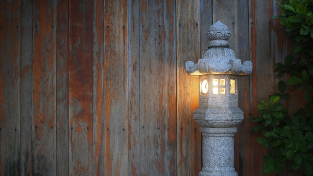Image of a Japanese stone lantern with lights on a wooden background.