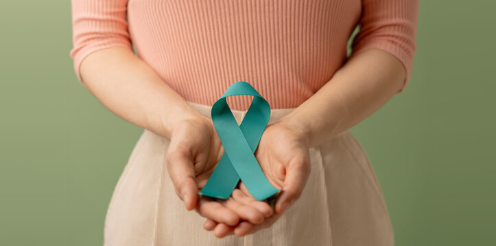 Ovarian and Cervical Cancer Awareness. Woman Holding Teal Ribbon on Lower Abdomen, Uterus, Female Reproductive System, Women's Health, PCOS and Gynecology