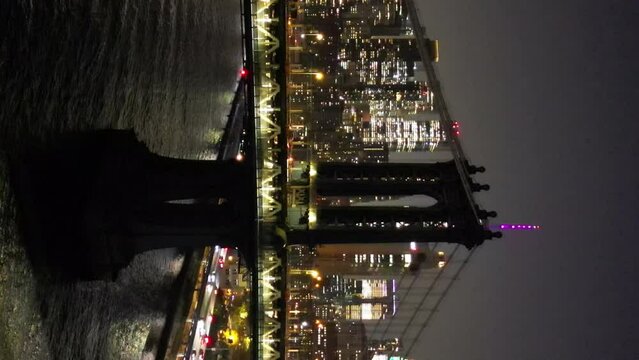 Aerial view of the night cityscape of New York. High-rise business centers in the downtown of the city. bridge over the thames river. High quality 4k footage