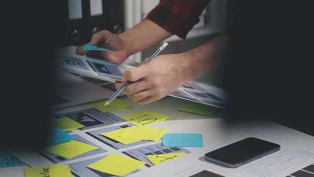 UX graphic designer planning application process development prototype wireframe for web smart phone. Creative digital development agency. in office