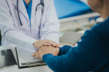 Cropped view of female doctor and Asian male patient talking about something, having consultation, doctor working in hospital writing prescription, health care and medical concept. - obrazy, fototapety, plakaty