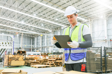 Inspector professional worker cardboard box warehouse export logistics standing checking authenticity sheet paper stamping according mold clipboard during inspection package storage in warehouse.