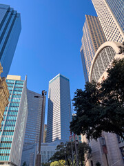 A skyline street view of Dallas Texas. These glass skyscrapers in the Texas lone star state on a clear blue sky day.  - obrazy, fototapety, plakaty